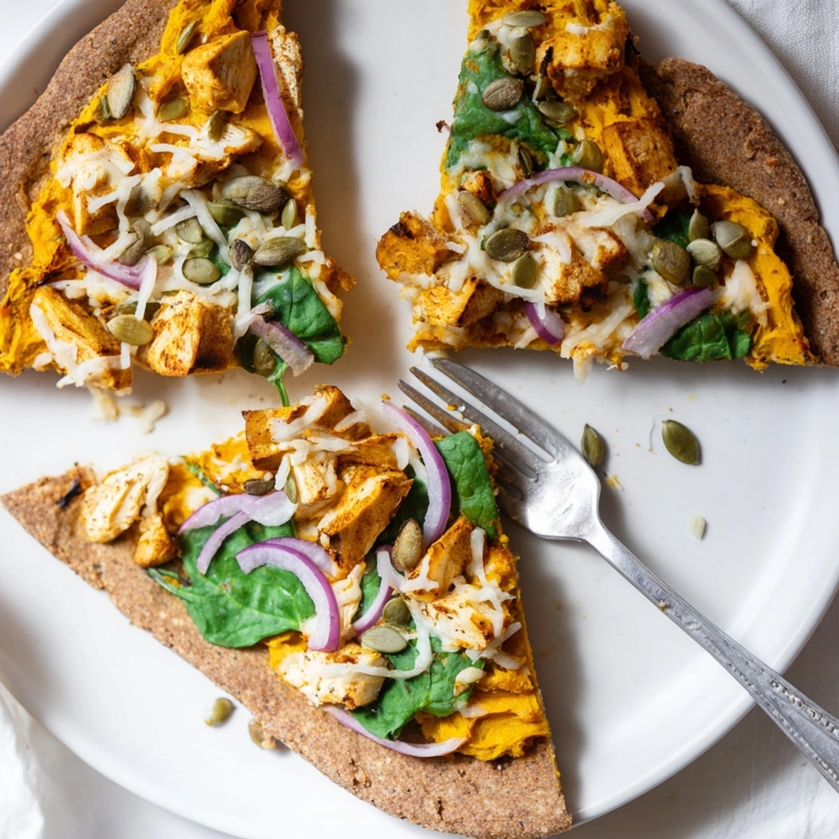 Close-up of a freshly-baked Protein Pumpkin Ricotta Pizza oozing melted mozzarella.