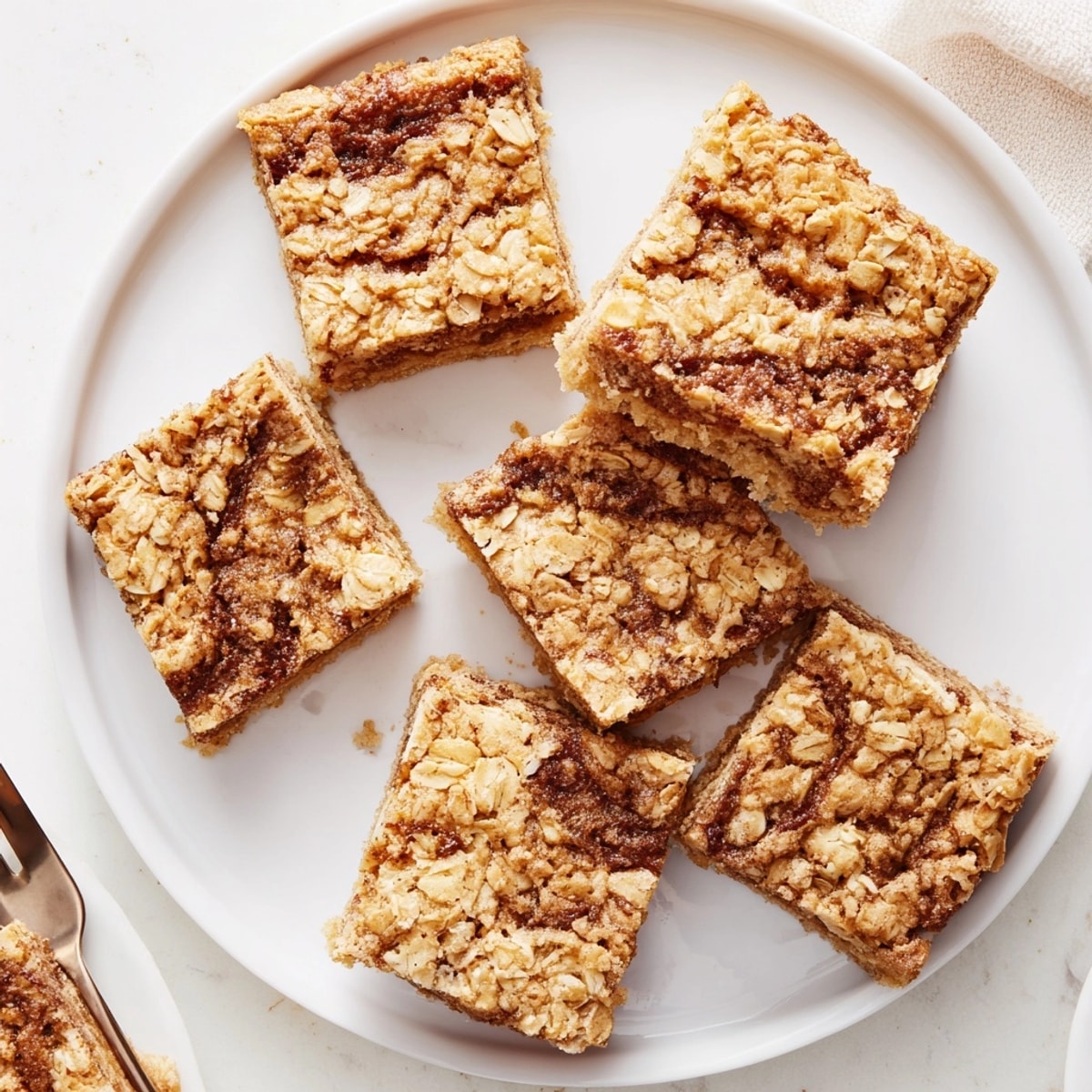 Golden-brown Cinnamon Swirl Oatmeal Blondies, fresh from the oven, a sweet, spiced dessert.