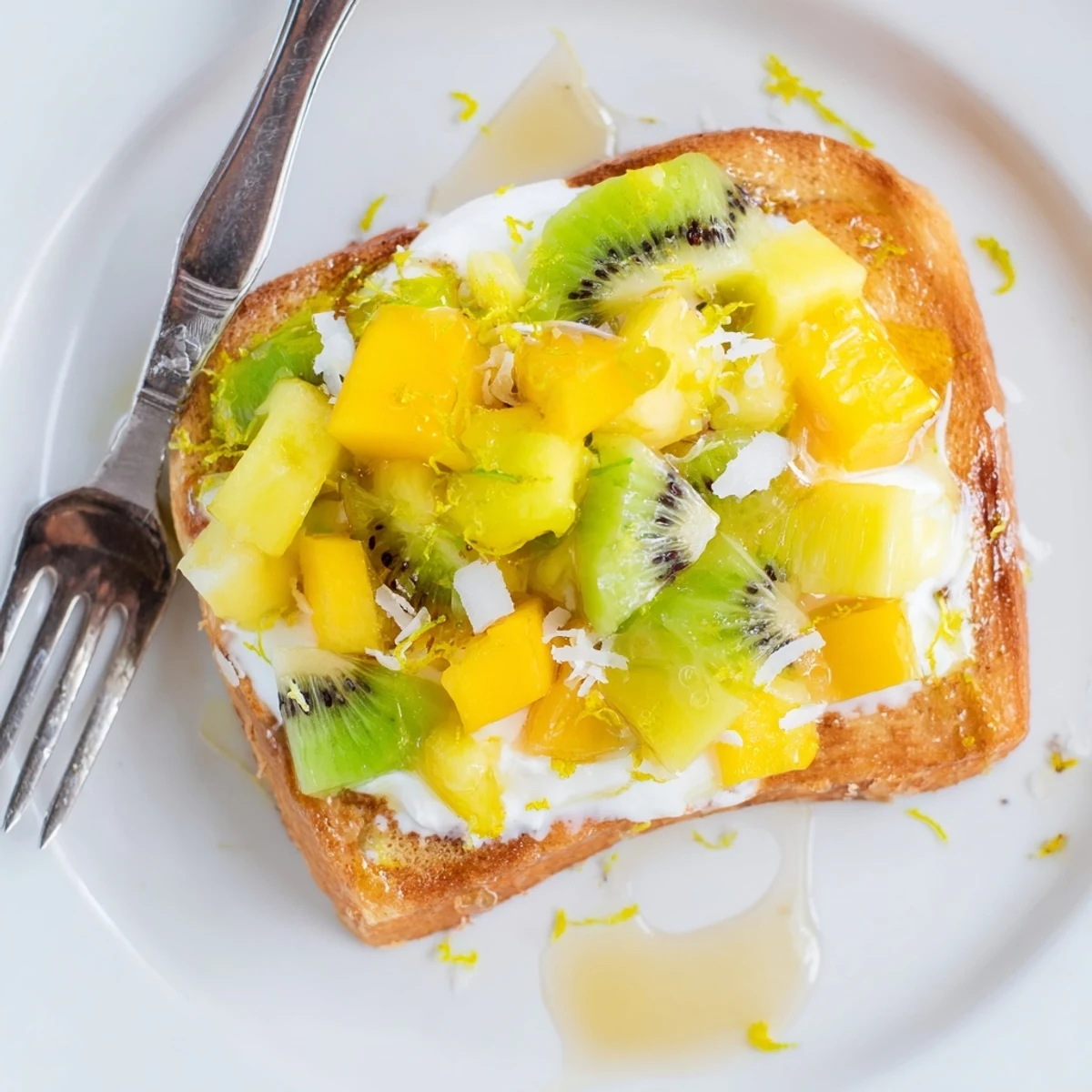 Vibrant yogurt-custard toast, drizzled with honey and garnished with lime zest.
