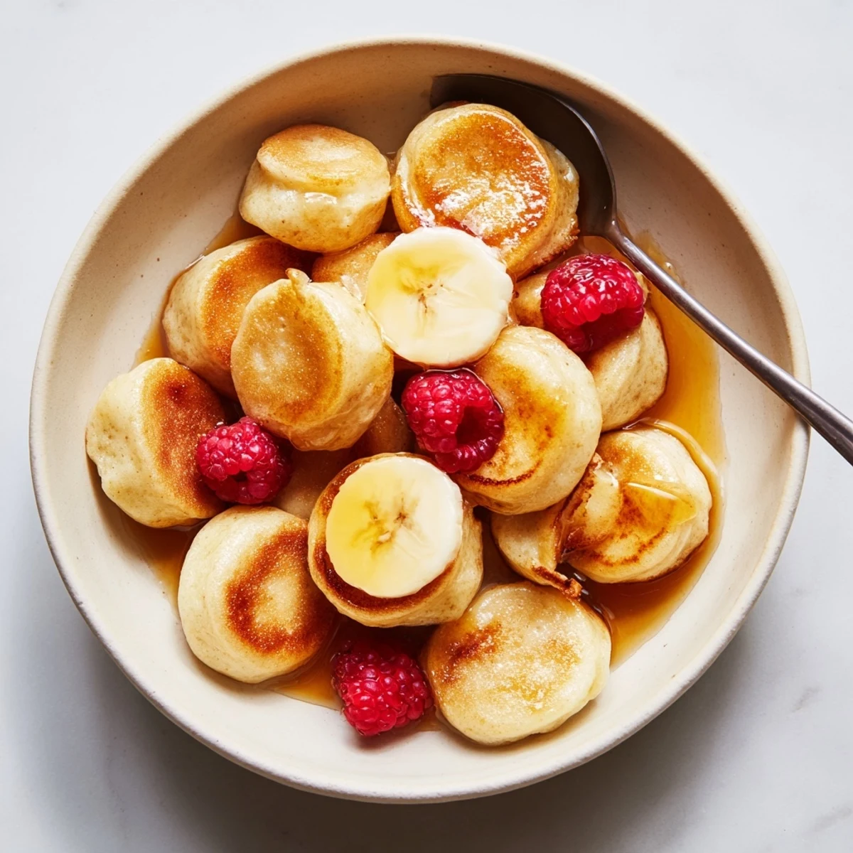 Bite-sized mini pancake cereal, fluffy and crispy, perfect with milk or honey drizzle.  