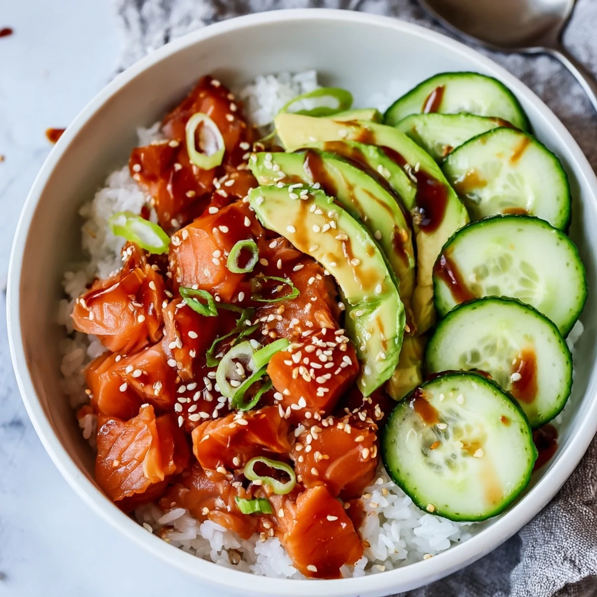 Delicious leftover salmon and rice bowl, topped with fresh avocado and cucumber.  