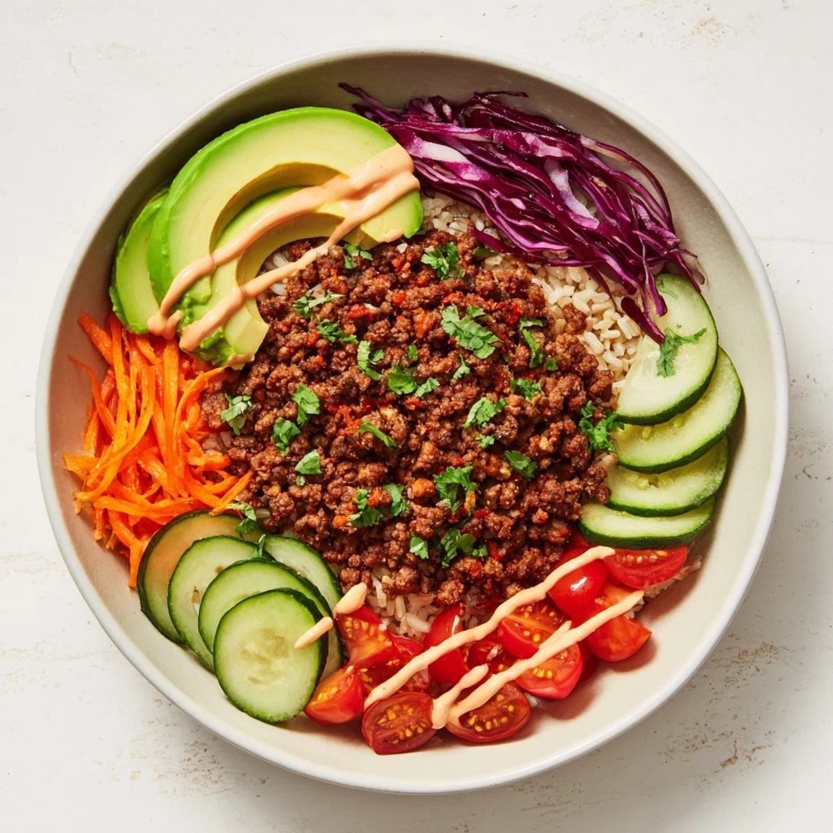 A delicious plant-based meat bowl topped with fresh vegetables and zesty sauce.  