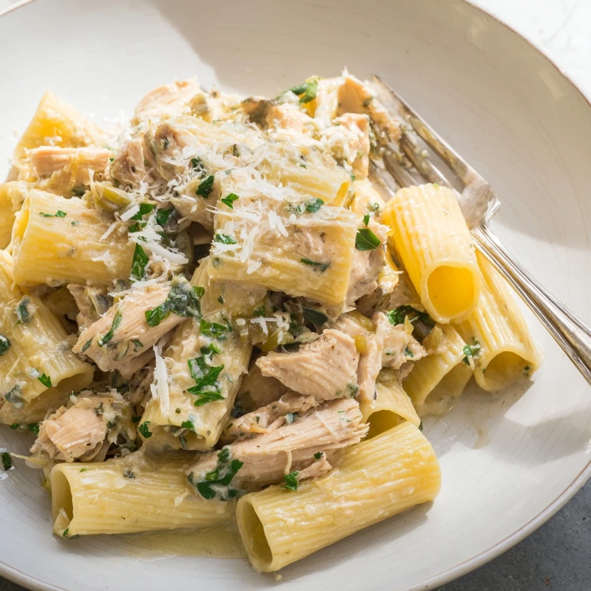 Creamy Garlic Parmesan Chicken Rigatoni topped with parsley and extra cheese for flavor.  