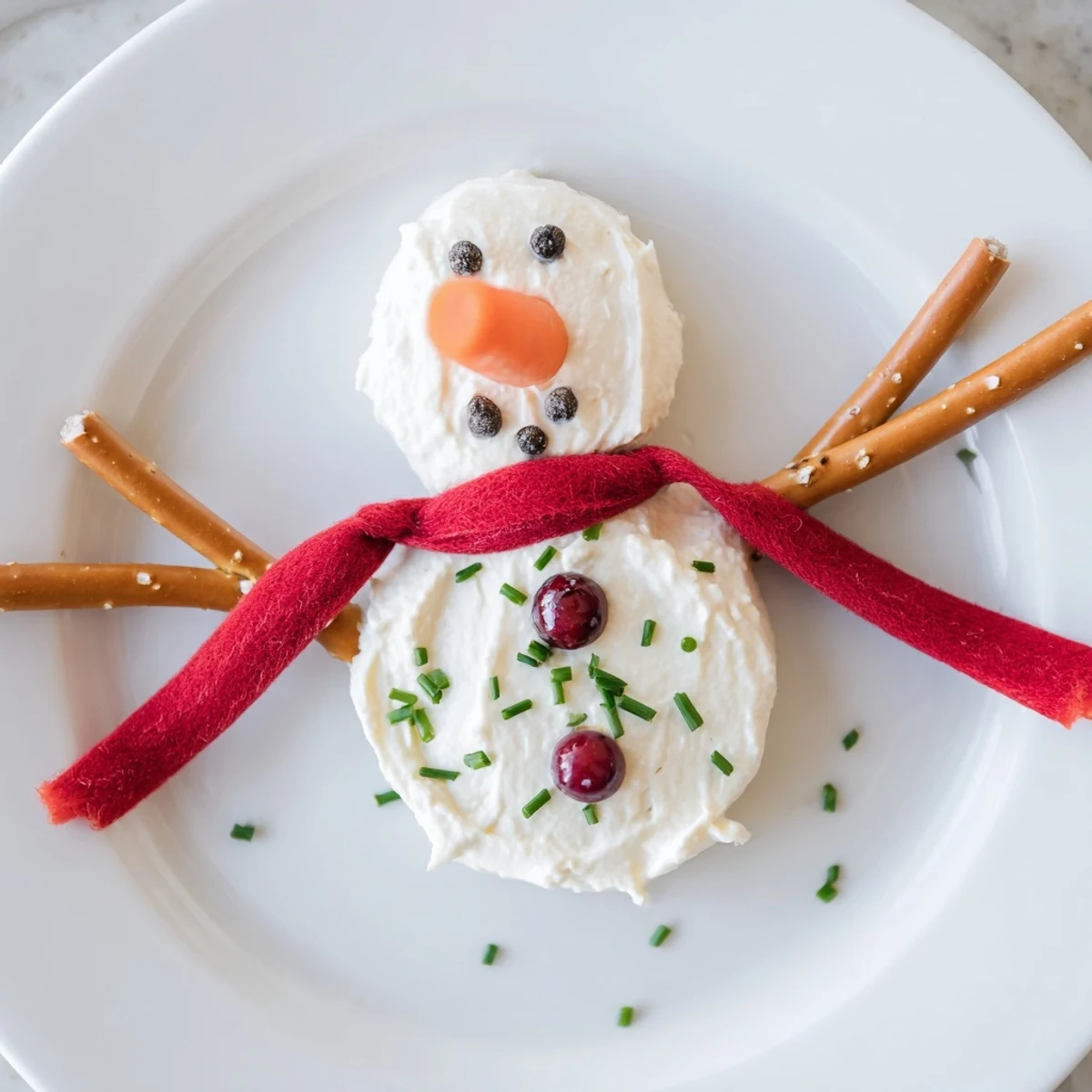 A whimsical Melted Snowman Dip, creamy and delicious, ready to scoop with crackers.