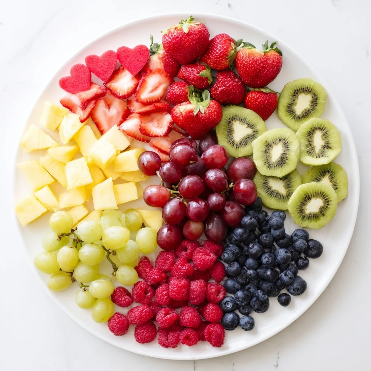 A beautiful sweetheart fruit board overflowing with juicy strawberries, grapes, and heart-shaped watermelon slices to enjoy.