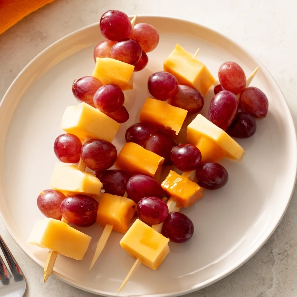 Cheese and grape skewers arranged beautifully on a platter, ready to grab for a tasty snack.