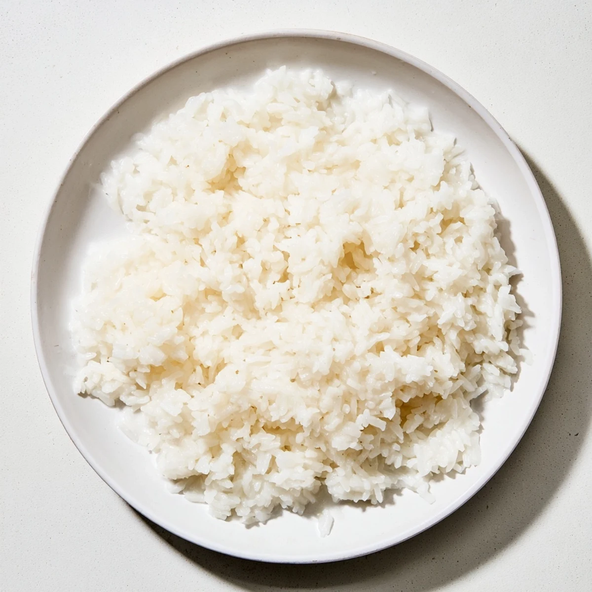 Steaming bowl of coconut jasmine rice, fragrant and subtly sweet, looks perfect for family dinner.