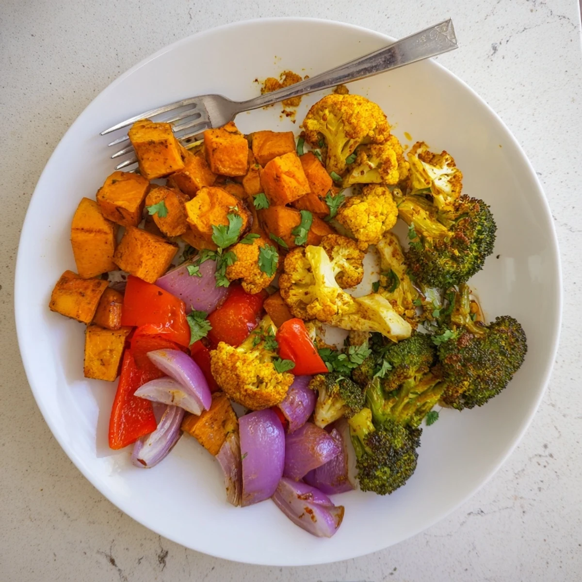 Roasted Anti-Inflammatory Turmeric Roasted Vegetables on a baking sheet with golden, caramelized edges and vibrant orange and green hues.