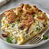 Closeup of Shrimp Alfredo Casserole served in a white dish, showcasing tender shrimp and rich sauce.