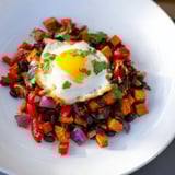 Vibrant skillet of Sweet Potato & Black Bean Breakfast Hash, seasoned and ready for a savory breakfast.