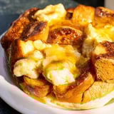 Warm, custardy French toast bake topped with a cinnamon-sugar crust, ready to serve with berries.