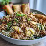 Savory ground chicken and crisp cabbage mix in this one-pan Crispy Chicken Fried Rice with Egg Roll Flavors, ready to eat.