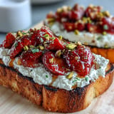 Vibrant Strawberry Honey Ricotta Toast topped with crunchy pistachios, a perfect bite.