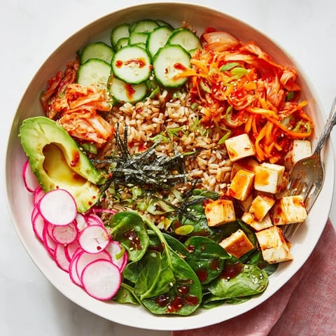 A colorful fermented vegetable bowl with tangy kimchi and fresh greens.  
