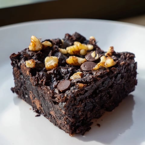 Warm, gooey sweet potato brownies with melted dark chocolate chips, ready to serve and enjoy.