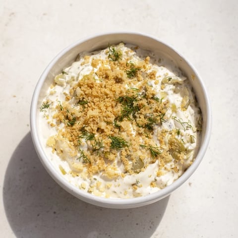 Creamy Fried Pickle Dip, ready to serve with crunchy chips, offering a tangy appetizer experience.