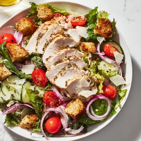 Quick Crunchy Lemon Parmesan Chicken Salad, showcasing tender chicken over fresh greens with a bright lemon dressing.