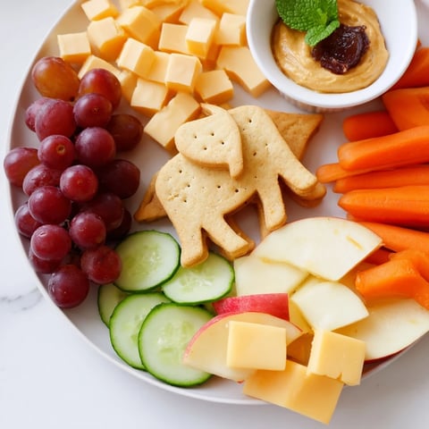 Elephant Cracker Board: A colorful, inviting snack board laden with crackers, cheese, fruits, and dips.