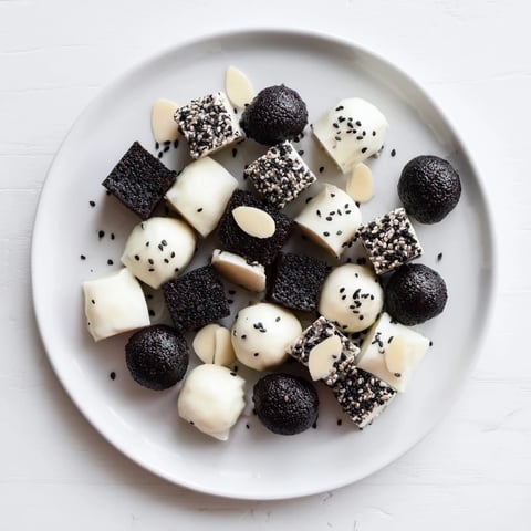Black and White Formal Affair appetizer platter with olives, mozzarella, and geometric rye bread.