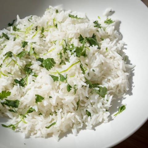Fluffy cilantro lime rice, infused with citrus, beside a grilled chicken breast.