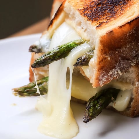 Asparagus & Brie Grilled Cheese sandwich with golden, buttery sourdough and melted cheese, ready to serve.