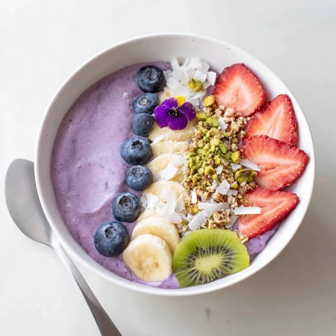 Colorful, creamy smoothie bowls featuring purple yam and banana for a nutritious start.  