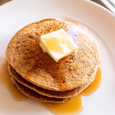 Warm, spiced gingerbread pancakes, fluffy and light, served with melting butter and sweet maple syrup.