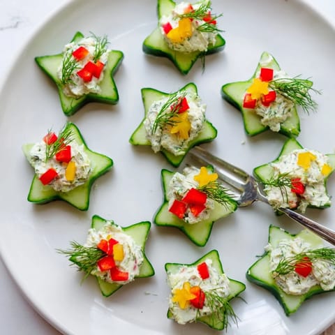 Zesty Holiday Star Cucumber Bites featuring creamy cream cheese and fresh, vibrant dill, ready for a party.