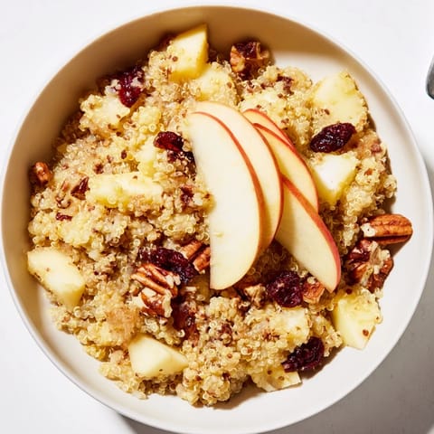 Close-up of a warm Apple Cinnamon Quinoa Bowl, inviting with cinnamon scent and diced apples.