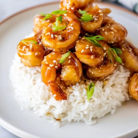 Glazed Honey Garlic Shrimp glistening in a skillet, perfect for a quick and easy weeknight meal.