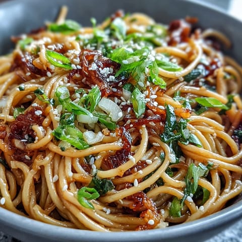 Golden wheat noodles coated in fragrant ginger-scallion sauce and sweet-salty soy glaze for an umami-rich dinner.  