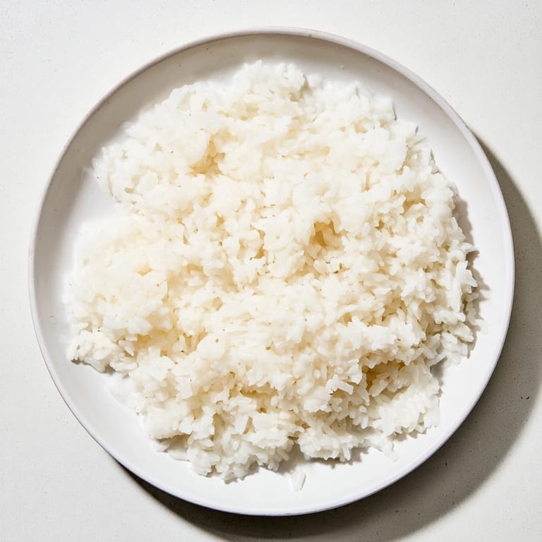 Steaming bowl of coconut jasmine rice, fragrant and subtly sweet, looks perfect for family dinner.