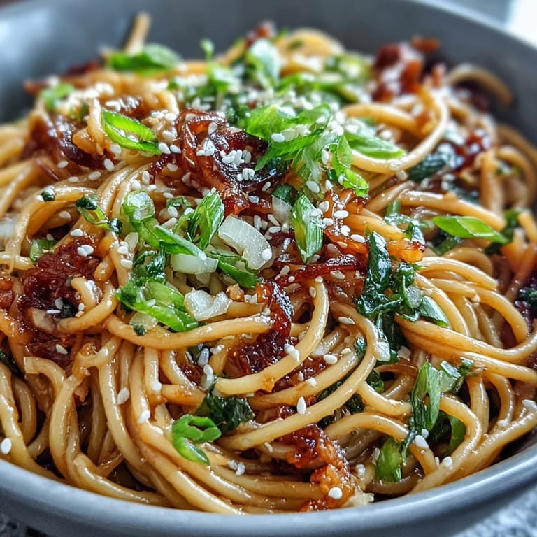 Golden wheat noodles coated in fragrant ginger-scallion sauce and sweet-salty soy glaze for an umami-rich dinner.  