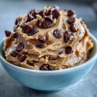 A creamy, protein-packed cookie dough with rich chocolate chips, perfect for a healthy snack or post-workout treat.