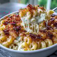 Creamy baked mac and cheese with crispy bacon crumbs, golden cheese sauce coating tender pasta for ultimate comfort.