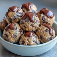High-protein cookie dough bites with oats, chocolate chips, and nut butter for a healthy, no-bake snack.  